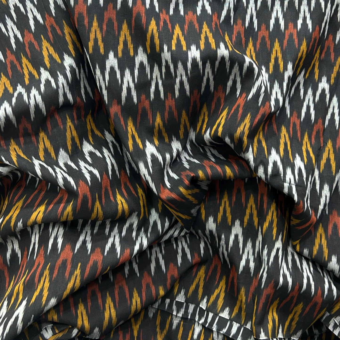 Cotton Mercerised Ikkat Black With White Red and Yellow Woven Fabric
